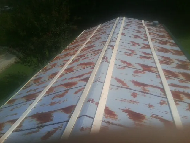 Rusted metal roof panels with new wood purlins before replacement — Storm Damage Roof Repair in Rush City by Roofing Brothers